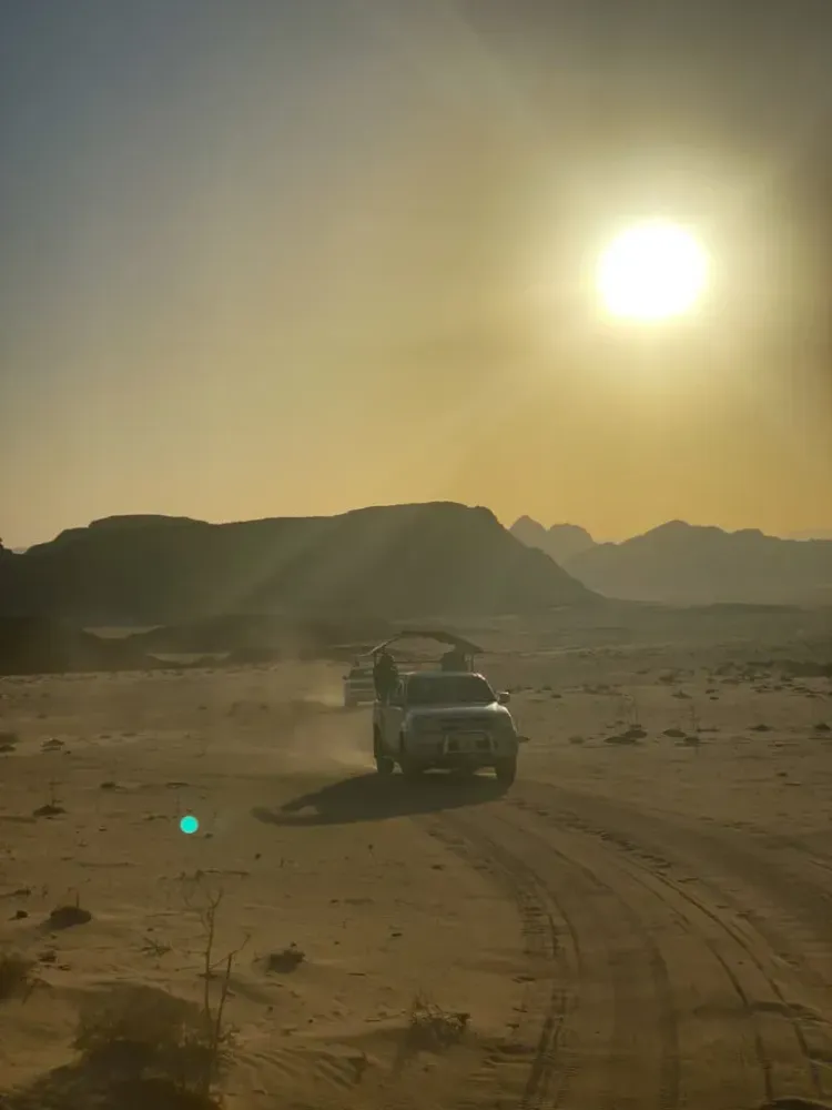 Hooded trucks running through the desert in Wadi Rum, Jordan